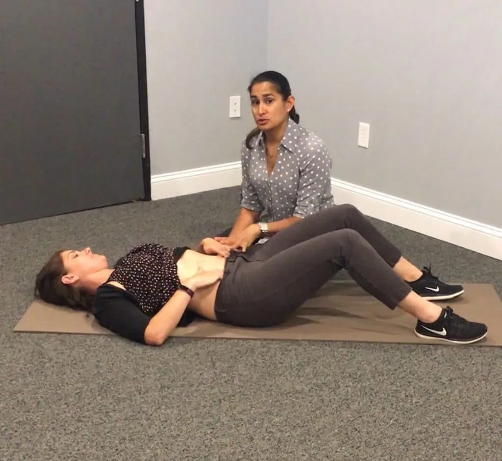 Hina showing one of the postpartum core exercises for TrA muscle