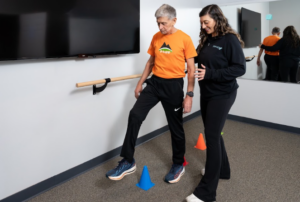 Therapist evaluating an athlete’s balance and movement patterns